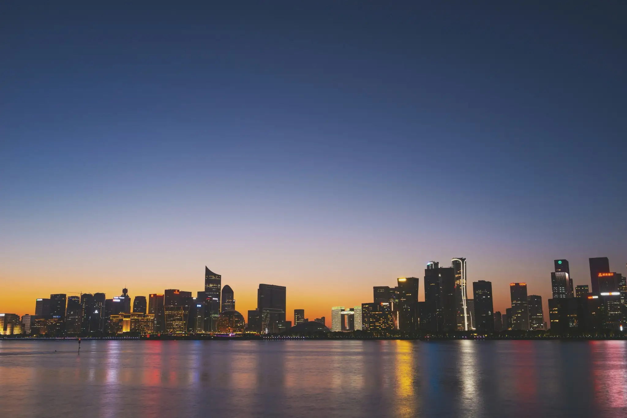 City skyline at dusk across open water