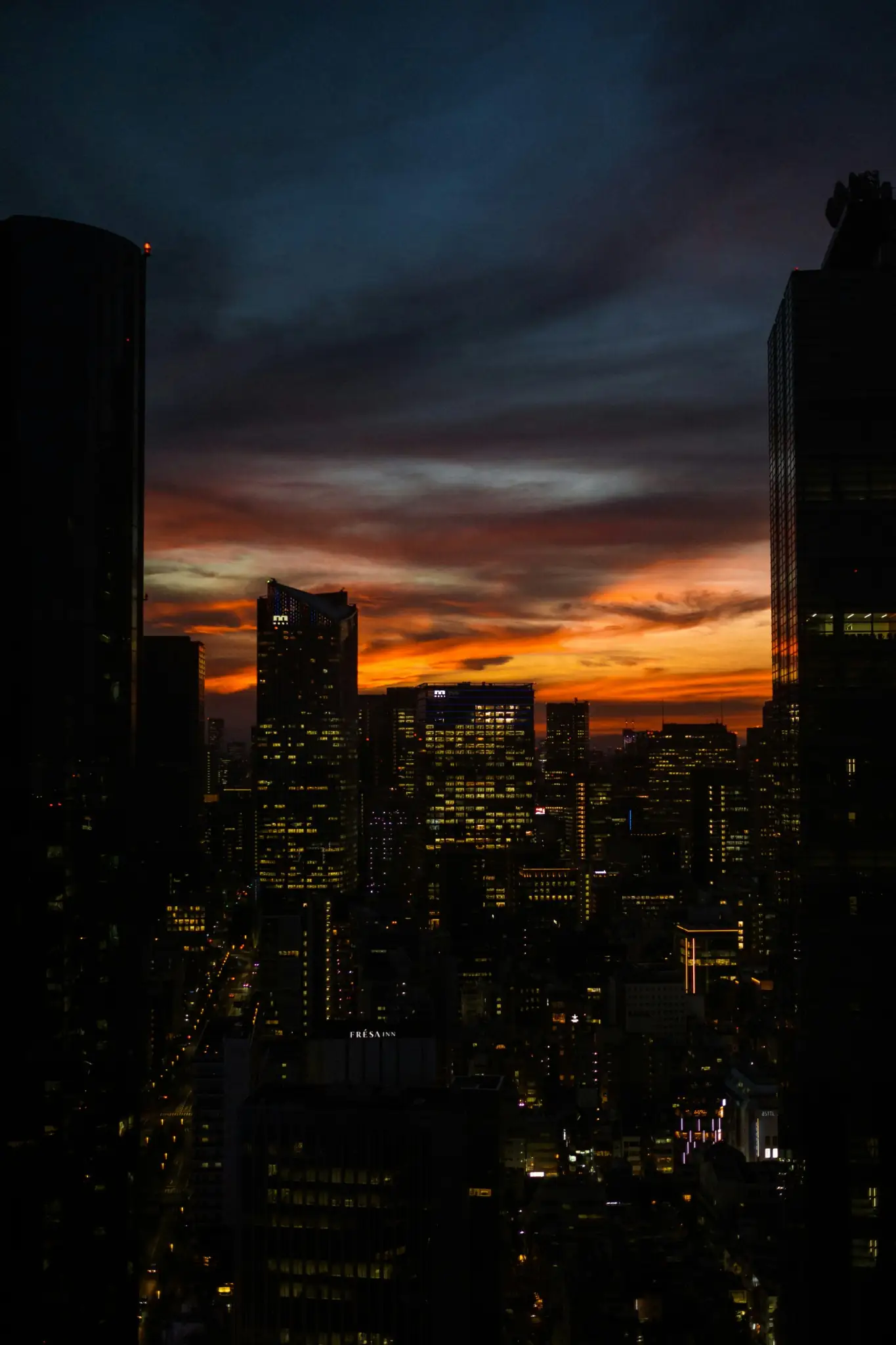 A tower at dusk against a low sky