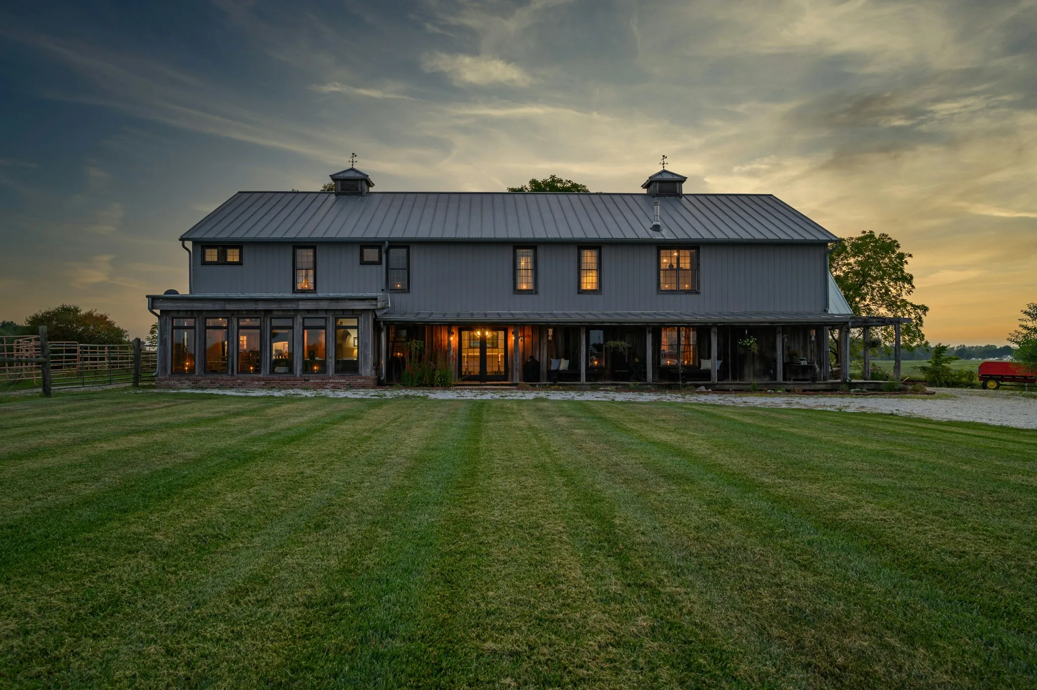 A residence at dusk with lit interiors